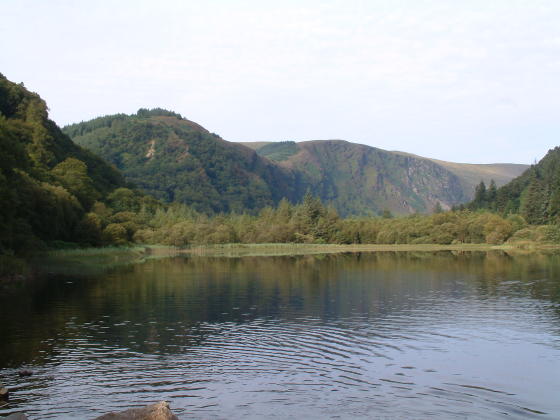 Looking across a lake to trees and hills